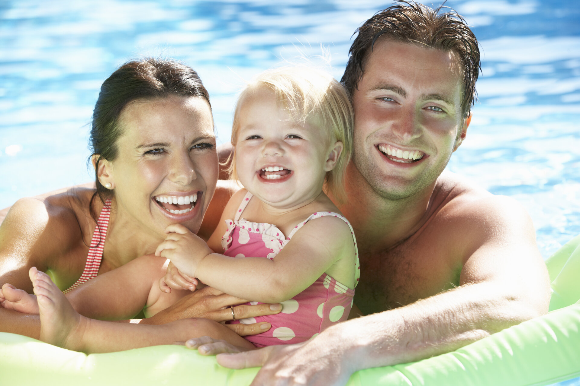 family swimming in pool at daytona beachside hotel